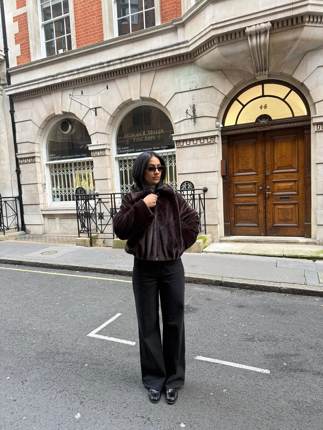 Dark plush cropped jacket with black wide-leg trousers