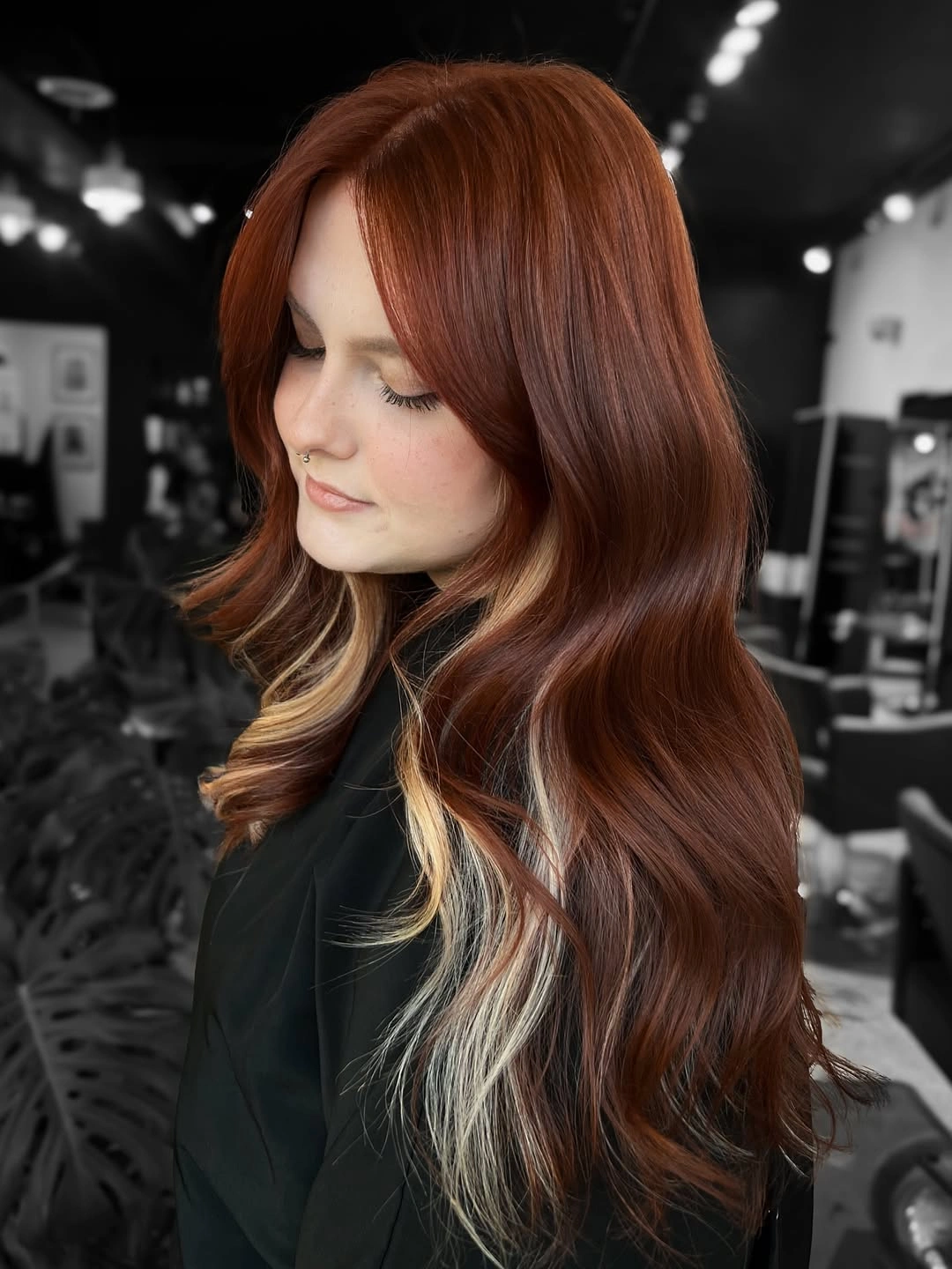 Long auburn waves with blonde ribbons near the face