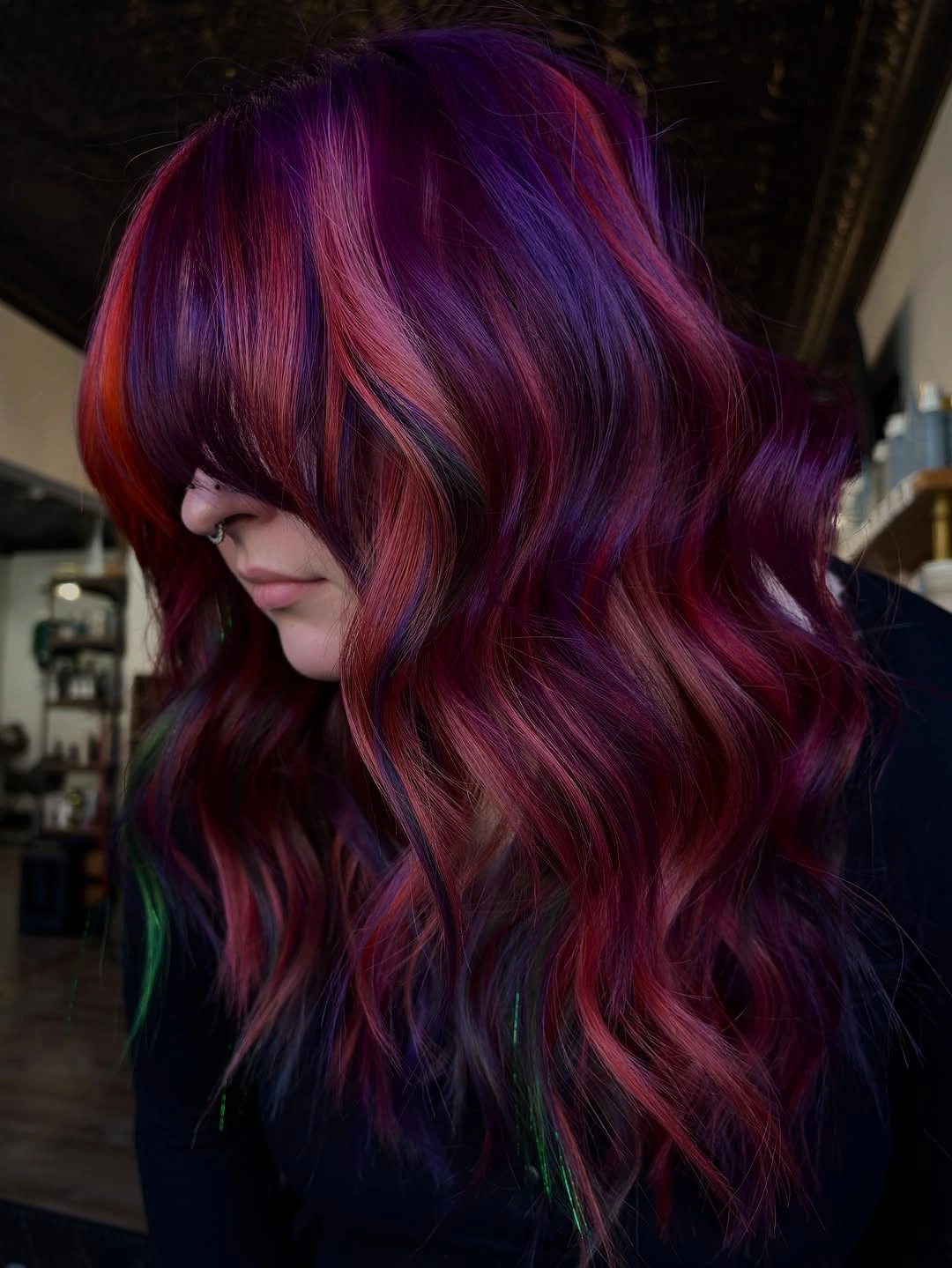 Shoulder length purple waves with magenta and green accents