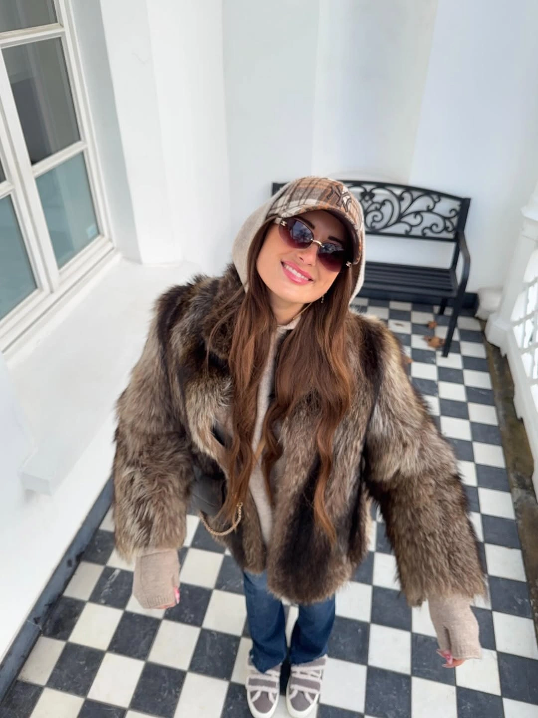 Brown fur-textured coat with jeans and beanie