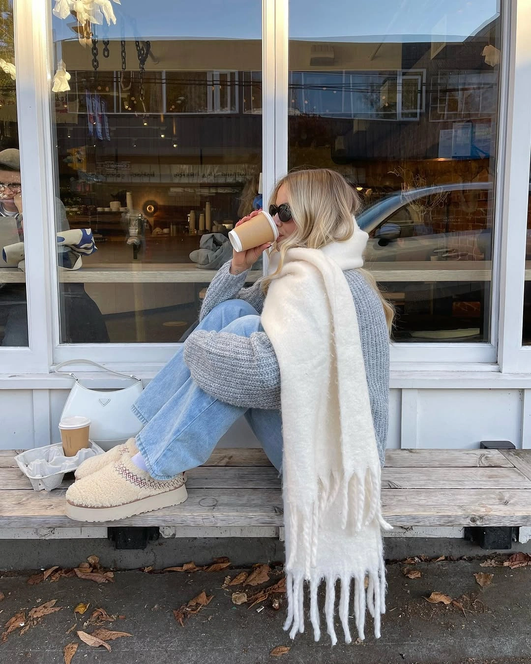 Oversized cream scarf with blue sweater and light jeans