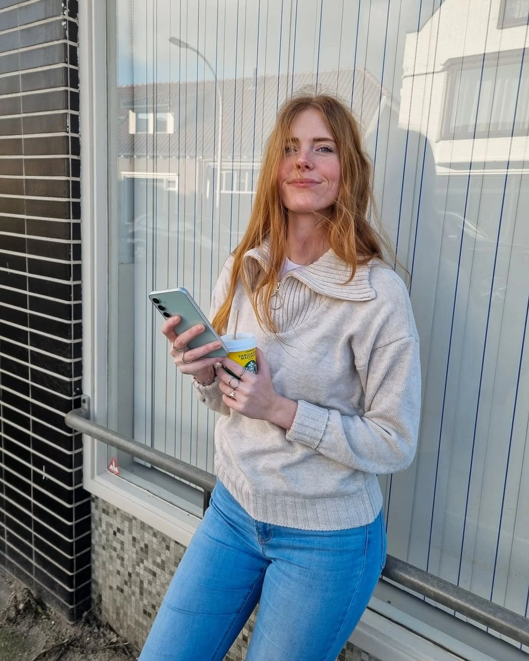 Light gray sweater paired with bright blue jeans