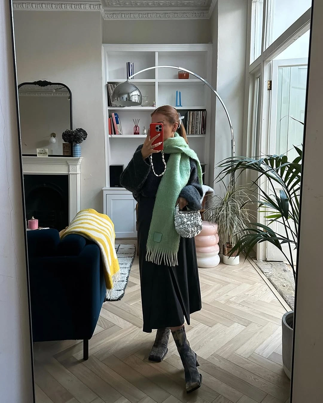 Mint green scarf with dark long outfit and boots