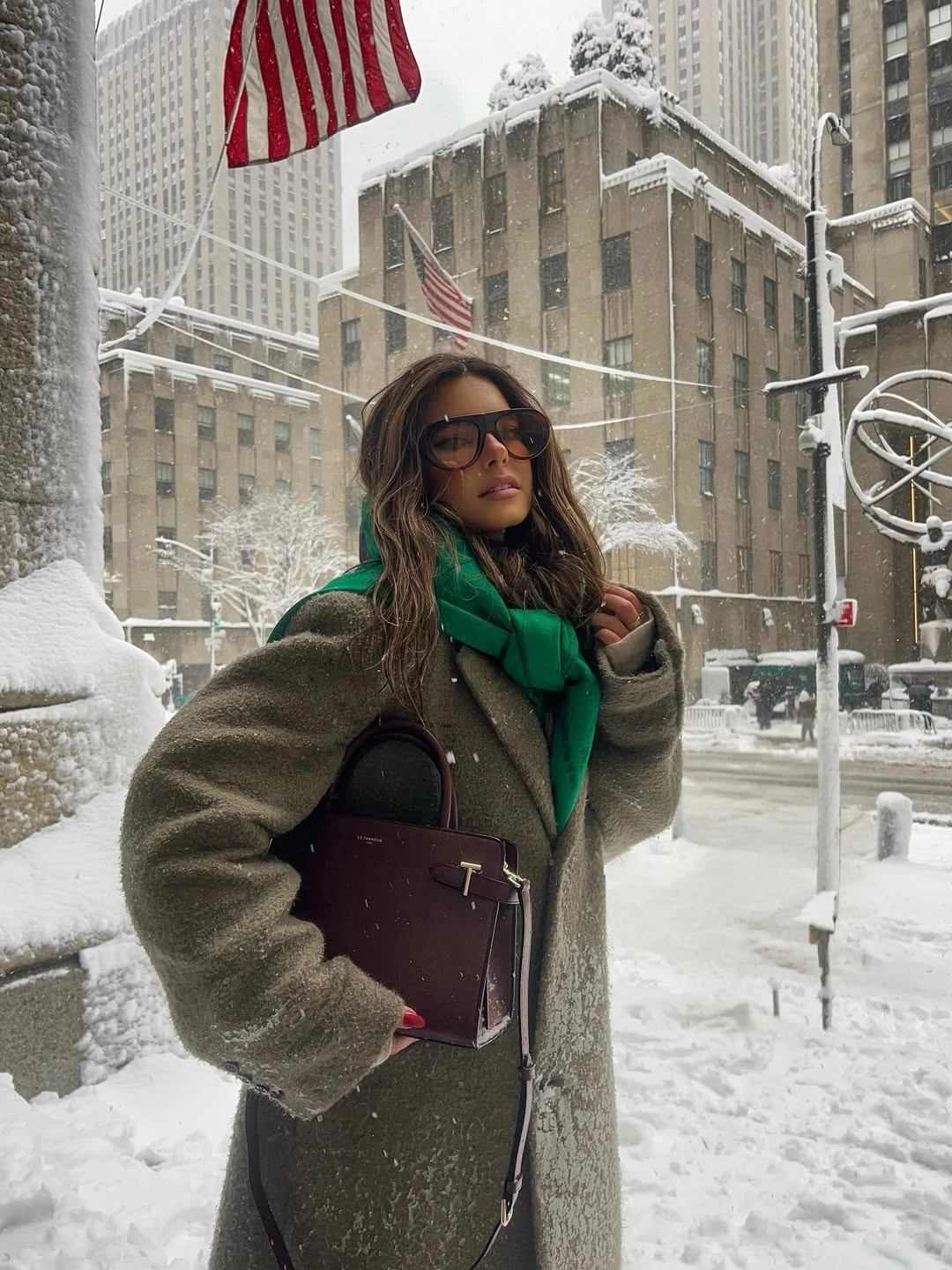Olive-gray textured coat with green scarf and burgundy handbag