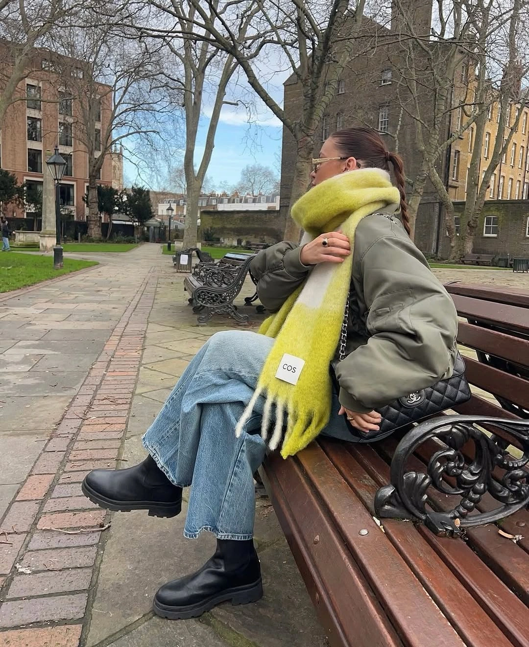 Olive padded jacket with lime scarf, jeans and black boots