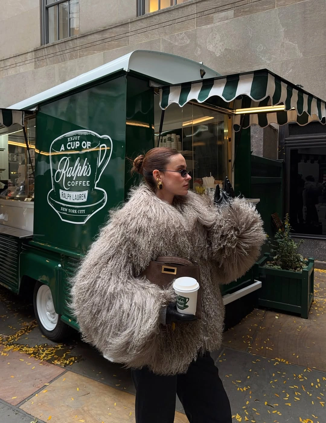 Oversized shaggy jacket with black trousers and brown bag