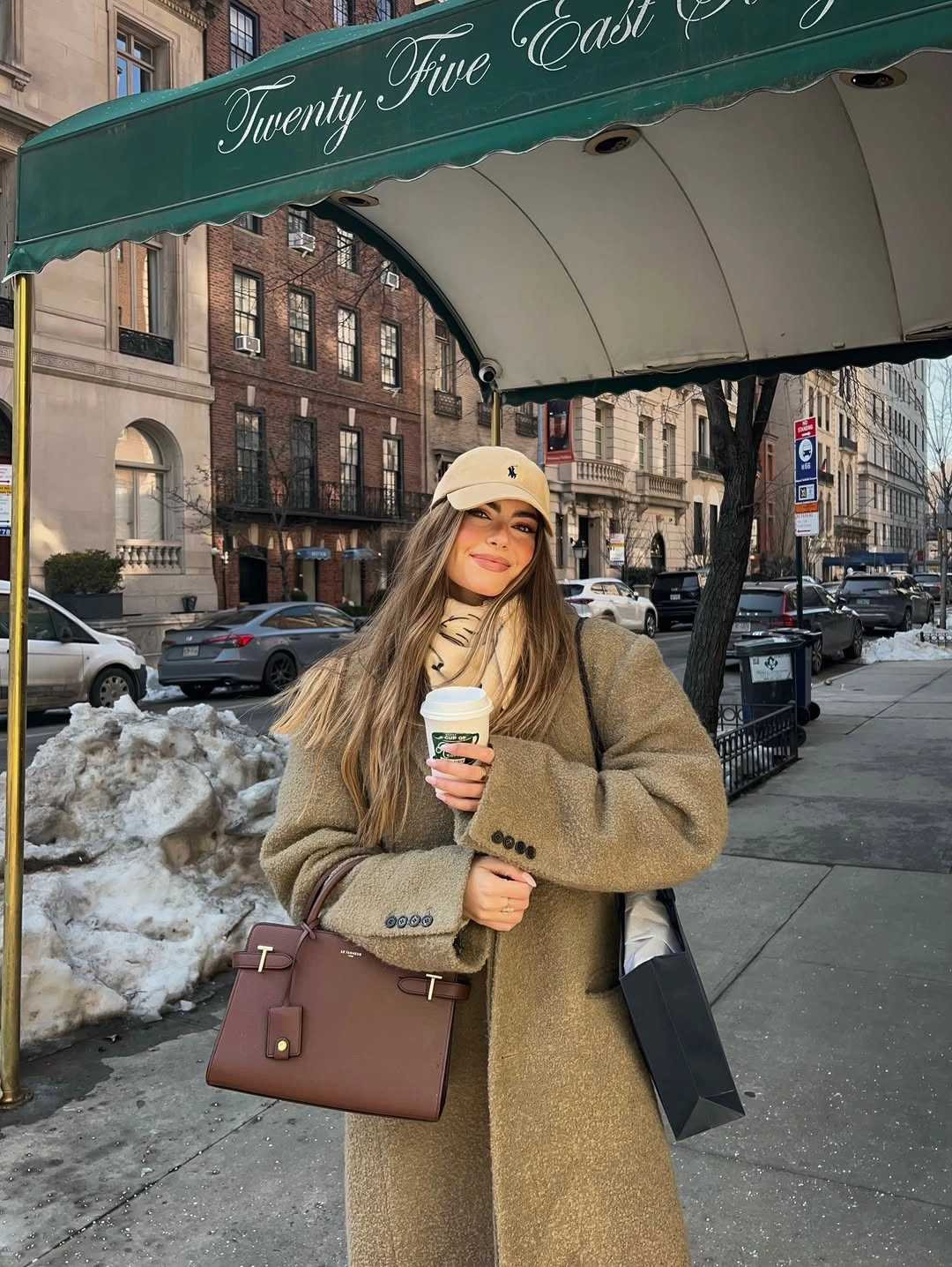 Muted long coat with beige scarf, cap and brown handbag