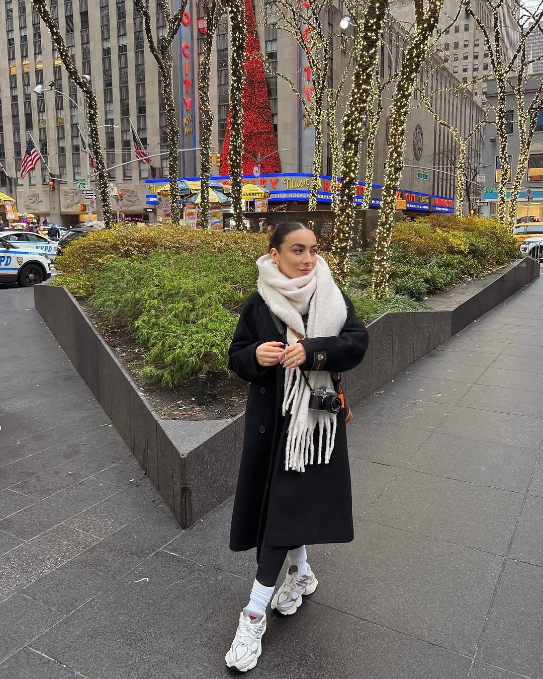 Black coat with white scarf, gray pants and chunky sneakers