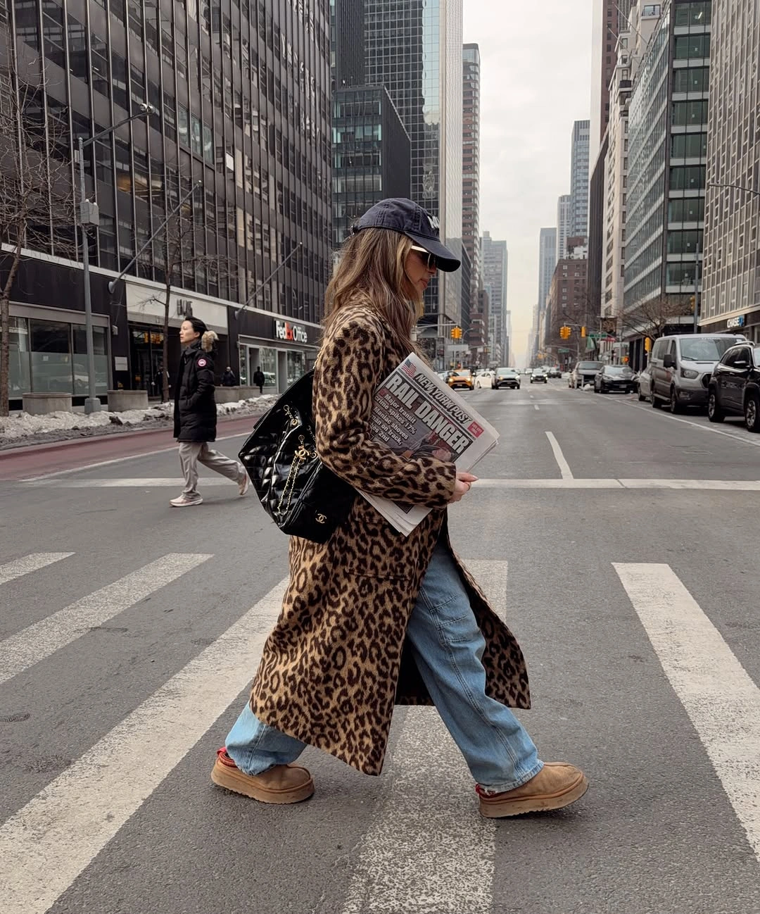 Animal print coat with wide jeans, tan boots and navy cap