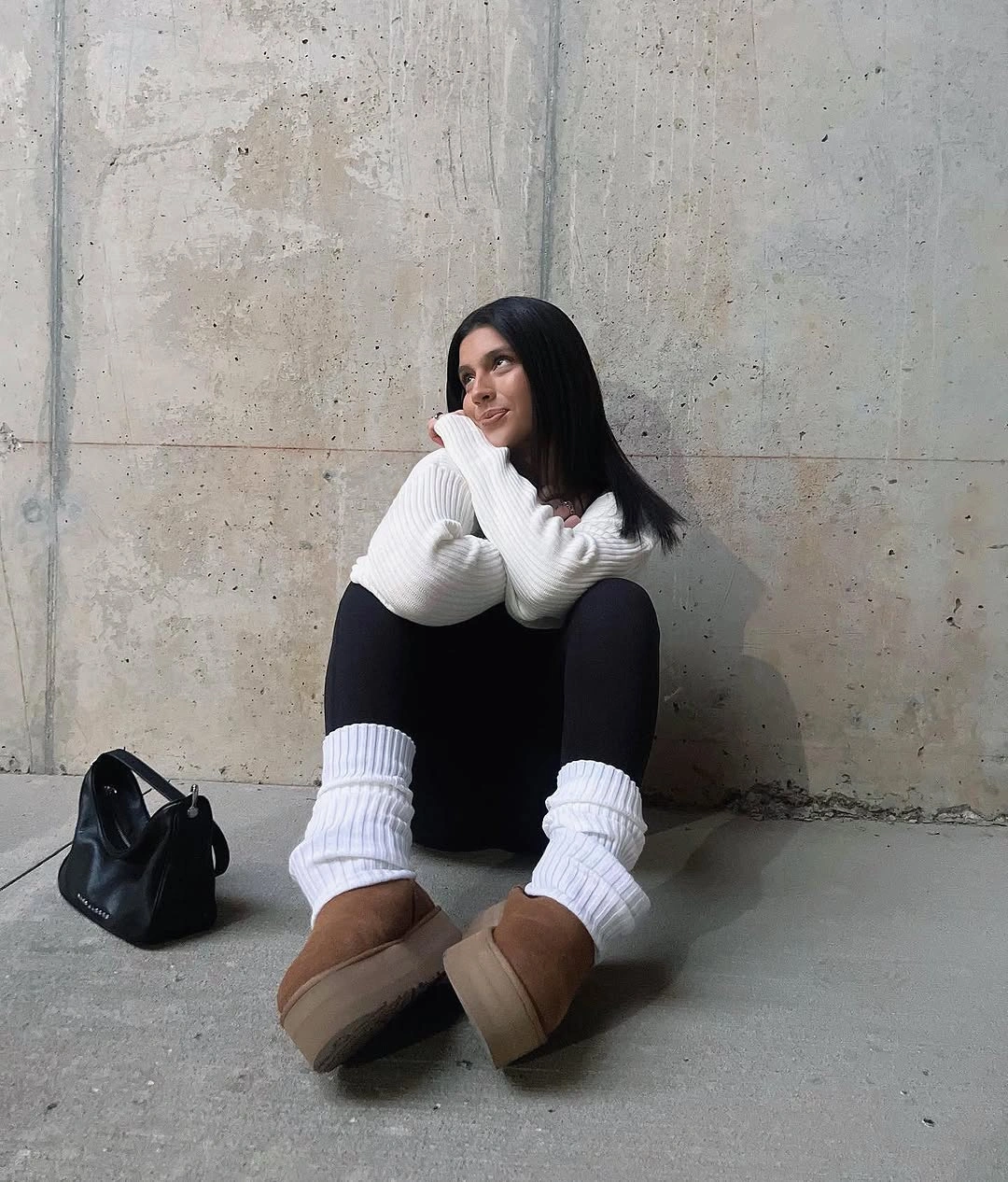 White turtleneck sweater with black leggings and tan shoes