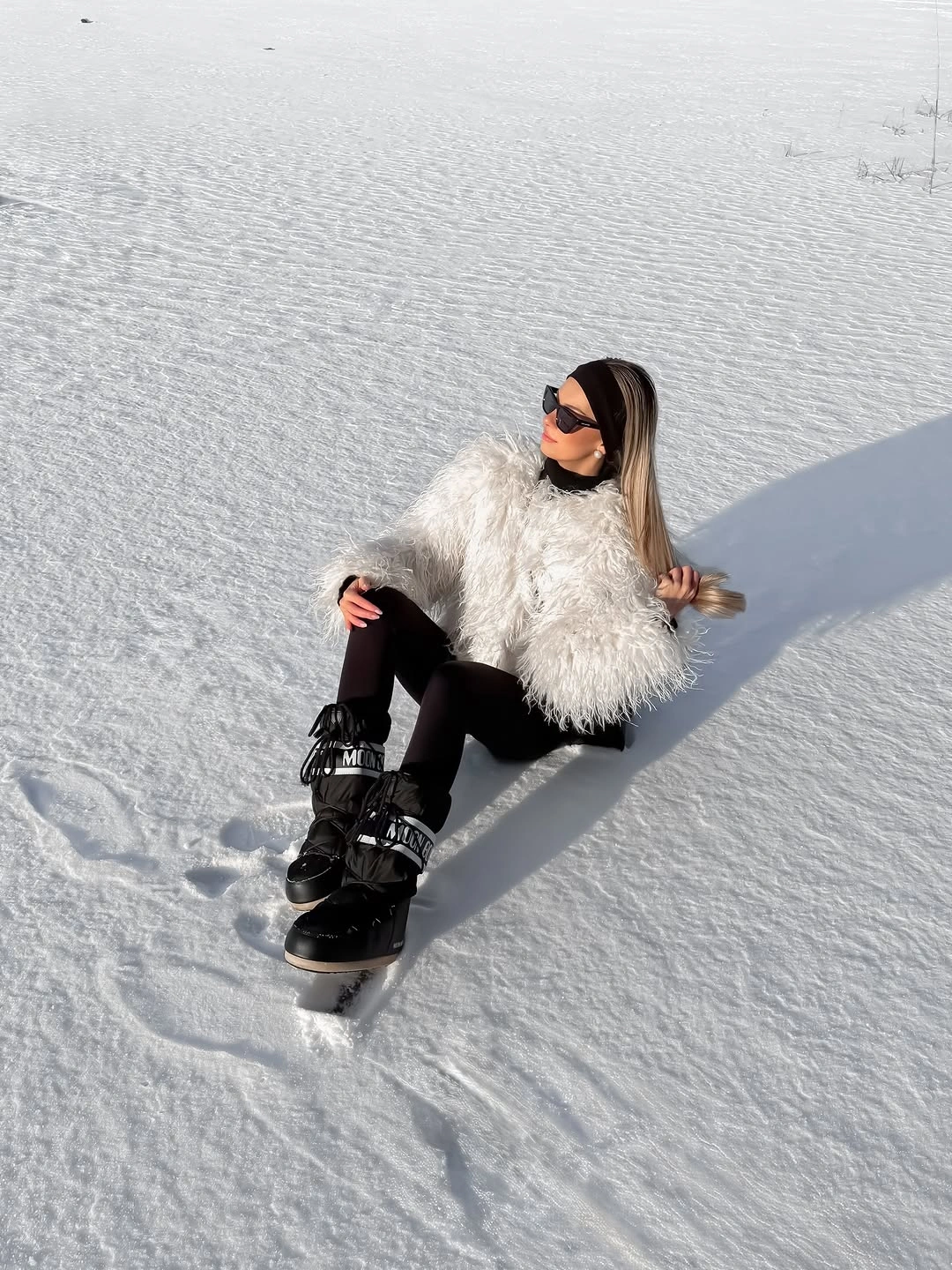 White fluffy jacket with black base and high-top sneakers