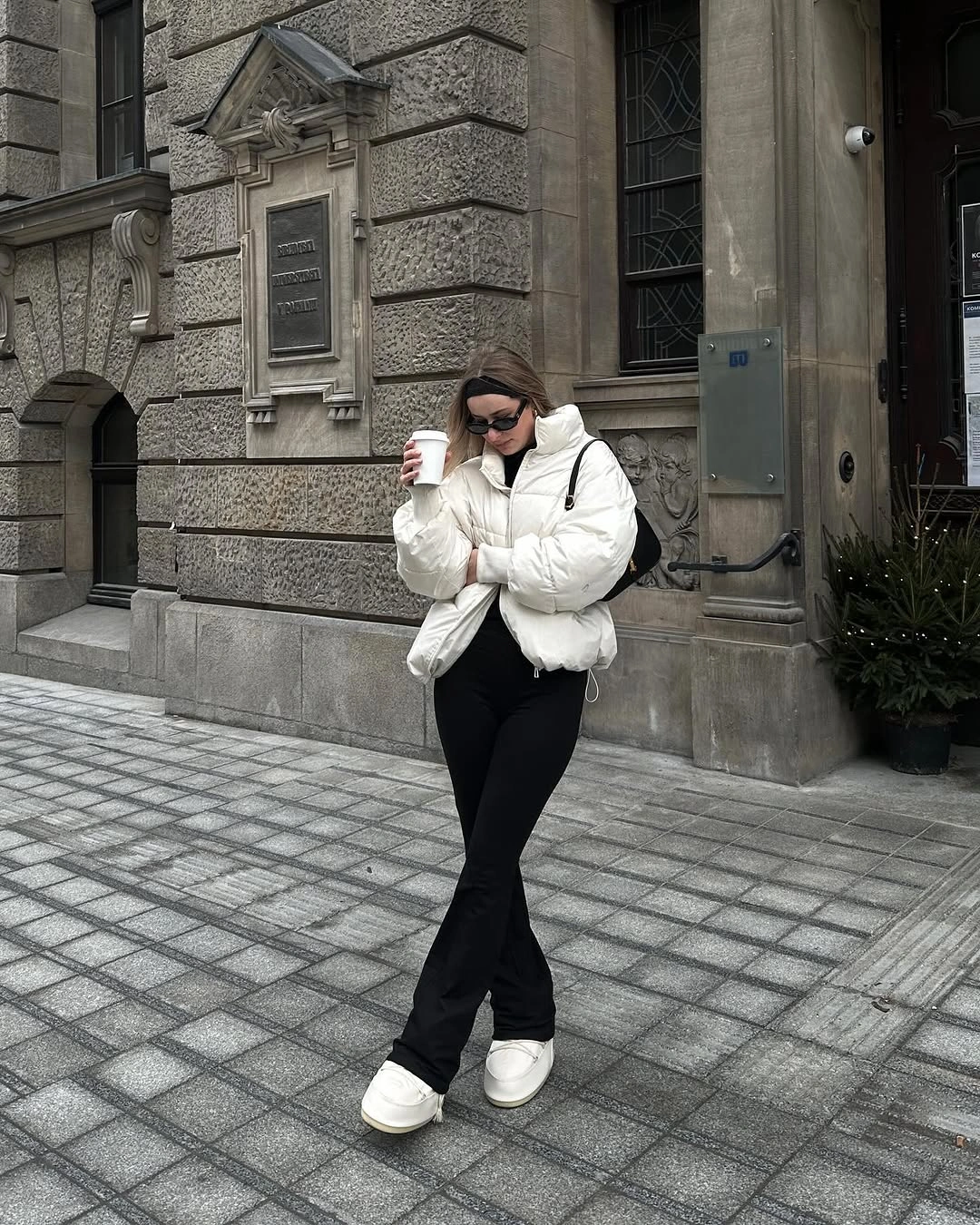 Tonal brown coat with turtleneck and structured shoulder bag