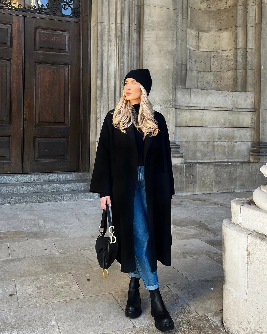 Long black coat, cuffed jeans and black ankle boots