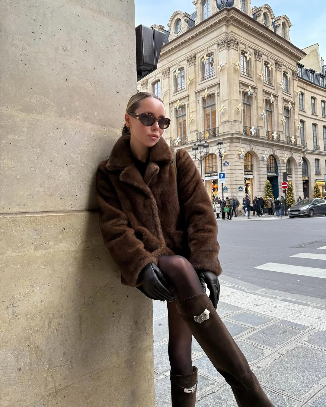 Brown plush jacket, sheer tights and buckled brown boots