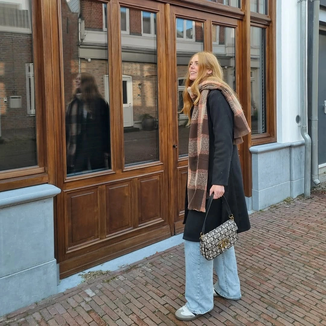Long black coat, plaid scarf and wide light jeans