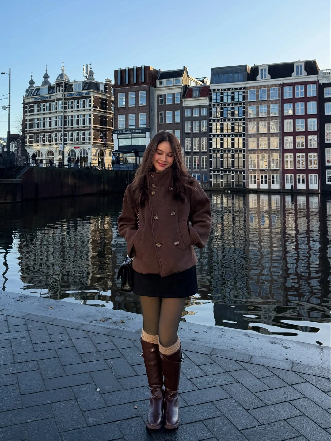 Cropped brown coat, black mini skirt and tall brown boots